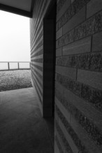 Modern Building with a Door Entrance and Sunlight in a Cloudy Day in Monte Generoso, Ticino,