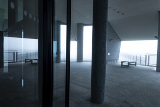Modern Building with Reflection and Sunlight in the Clouds in a Cloudy Day in Monte Generoso,