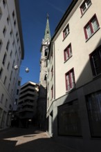 Beautiful City Street and Church Tower with Building and Shop with Blue Sky in a Sunny Summer Day