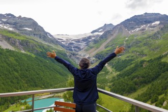 Woman with Arms Outstretched over the Beautiful Mountain Alp Grüm with Glacier and Alpine Lake Palü