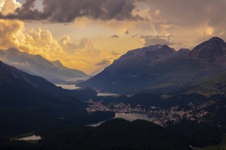 Beautiful Aerial View over Five Lakes and Swiss Alps and Cityscape in Sunset and Storm Clouds over