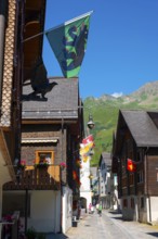 Beautiful City Street in Old Town with Houses and Hotel and with Mountain in a Sunny Summer Day in