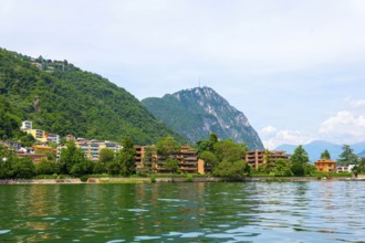 Elegant Building on the Mountain Side in a Sunny Summer Day on the Waterfront to Lake Lugano in