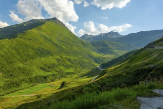 Beautiful Mountain Valley with Mountain Road in the Swiss Alps in a Sunny Summer Day in Andermatt,