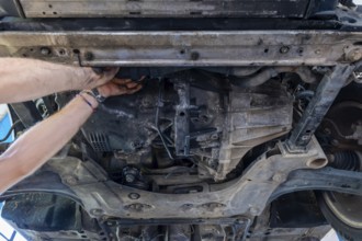 Mechanic Working on the Car Engine Below in Switzerland