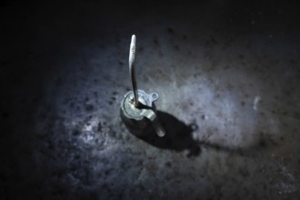 Old Dirty Oil Can with Sunlight and Shadow on a Metal Table in Mechanic Workshop in Switzerland