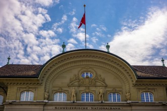 Beautiful Swiss National Bank with Flag in a sunny Day with Blue Sky and Clouds in City of Bern,