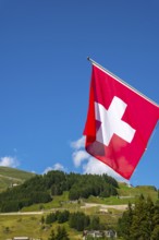 Beautiful Swiss Flag Against Mountain in the Swiss Alps in a Sunny Summer Day in Andermatt, Uri,