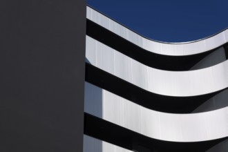 Beautiful Modern Concrete Design Building with Metal Balcony Against Blue Sky in Switzerland