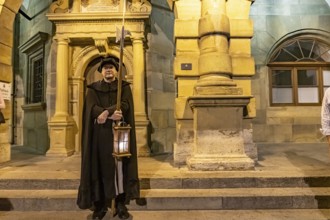 The night watchman in front of the town hall at dusk, Rothenburg ob der Tauber at dusk, Bavaria,