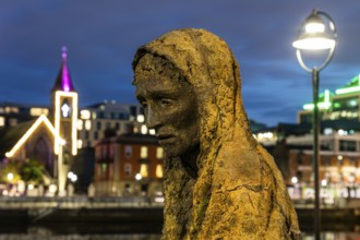 Sculpture of a starving person, Famine memorial, detail, night shot, Dublin, Ireland