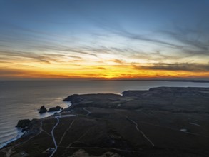 Sunset over Kynance Cove from a drone, Mount's Bay, Lizard Point, Cornwall, England, United Kingdom
