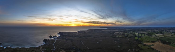 Sunset over Kynance Cove from a drone, Mount's Bay, Lizard Point, Cornwall, England, United Kingdom