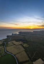 Sunset over Kynance Cove from a drone, Mount's Bay, Lizard Point, Cornwall, England, United Kingdom