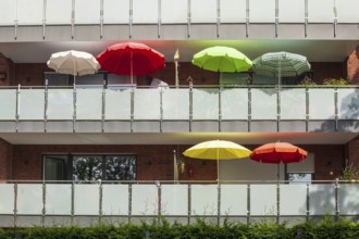Balconies with colourful parasols on a modern residential building, Bremerhaven, Bremen, Germany