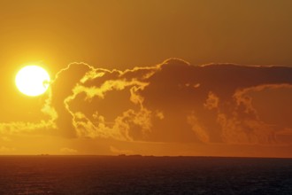 Dramatic sunset over the sea with glowing cloud formations, Orkney Islands, Scotland, Great Britain