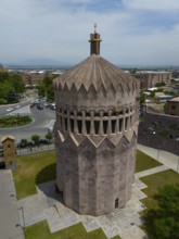 Distinctive stone tower in an urban setting under a blue sky, aerial view, Holy Archangel Church,