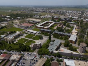 Urban landscape with buildings and green areas from a bird's eye view. Sunny atmosphere, aerial
