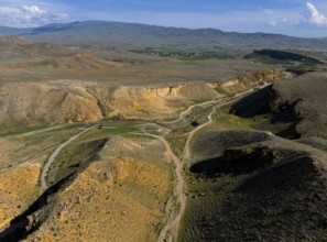 Aerial view of a vast mountain landscape with roads and little vegetation, aerial view, landscape