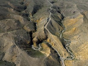 Aerial view of winding hills with a winding road through rocky landscape, aerial view, Angel's