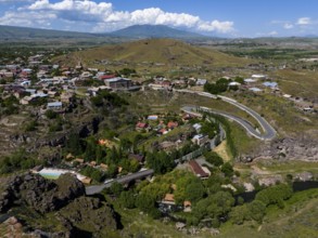 Vast landscape with a village, roads and a hill under a blue sky, aerial view, Oskahan, Oshakan,