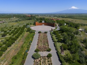 Landscape with symmetrical flower arrangements, a mountain in the background and a calm atmosphere,