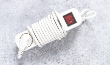 Power cord with switch and coiled design for easy storage in household or office settings