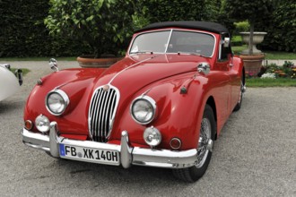 Jaguar Coupe, Vintage car, Red Jaguar vintage car with an elegant and classic design on gravel