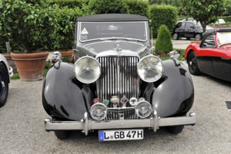 Jaguar MK IV, Oldtimer, Black vintage car with classic round headlights on display at a car