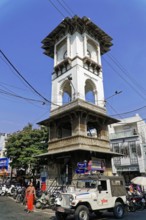 Udaipur, Rajasthan, North India, Asia, Historic tower in an urban setting under a clear sky,