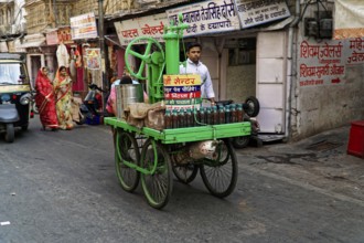 Udaipur, Rajasthan, North India, Asia, Man with traditional juice cart on busy street corner