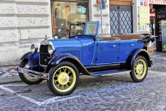 Prague, Czech Republic, Europe, Blue vintage car with open seats, standing decoratively on a