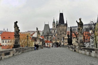 Prague, Czech Republic, Europe, Historic bridge with statues and towers in a cityscape