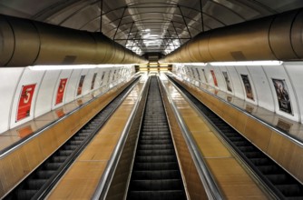 Long escalators in a modern underground station with futuristic lighting, Prague, Czech Republic
