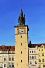 Prague, Czech Republic, Europe, A historic clock tower rises against the blue sky, surrounded by