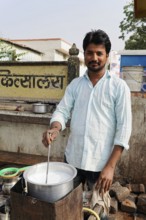 Kota, Rajasthan, North India, Asia, A vendor boiling milk in a pot on the street in a rural area,