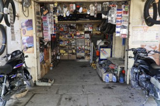 Kota, Rajasthan, North India, Asia, A small workshop shop with motorbike parts, tools and shelves