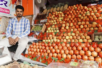 Kota, Rajasthan, North India, Asia, Vendor sitting at a market stall with a colourful selection of