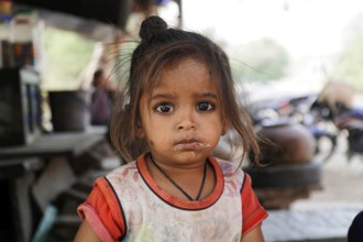 Kota, Rajasthan, North India, Asia, Girl with innocent, questioning look and dirt on her face,