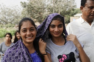Kota, Rajasthan, North India, Asia, Two smiling woman with headscarves pose friendly in nature,