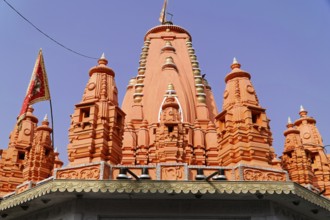 Kota, Rajasthan, North India, Asia, Bright red temple tower with Hindu architecture in the blue