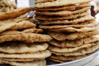 Kota, Rajasthan, North India, Asia, Side view of fried flatbreads stacked on a tray, India