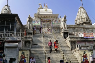 Entrance to Jagdish Temple, Udaipur, People climbing the steps to a temple flanked by statues under