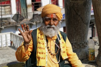 Udaipur, Rajasthan, North India, Asia, An elderly man sits relaxed, wearing a turban and