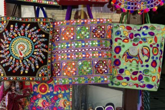 Udaipur, Rajasthan, North India, Asia, Three colourful bags with traditional patterns and elephant