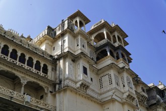 Udaipur, Rajasthan, North India, Asia, White palace with ornate traditional windows and blue sky in