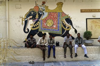 Udaipur, Rajasthan, North India, Asia, Several men sitting in front of an artistically painted