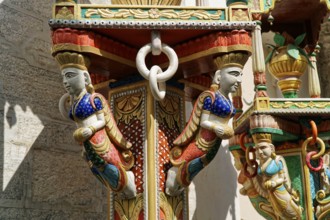 Udaipur, Rajasthan, North India, Asia, wood carving with Indian figures in bright colours and