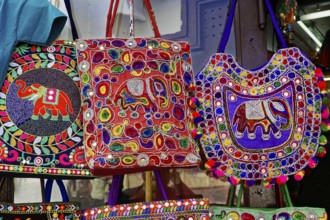 Udaipur, Rajasthan, North India, Asia, Different coloured embroidered bags with elephant patterns