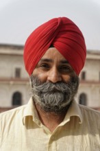 Red Fort, Agra, Uttar Pradesh, India, man with turban and beard smiling warmly, traditionally